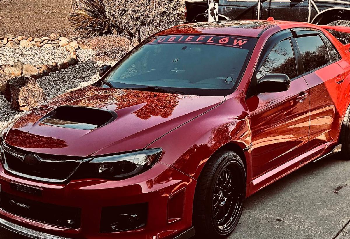 Candy-red Subaru WRX with a mirror-finish paint correction and ceramic coating by Diamond Detail